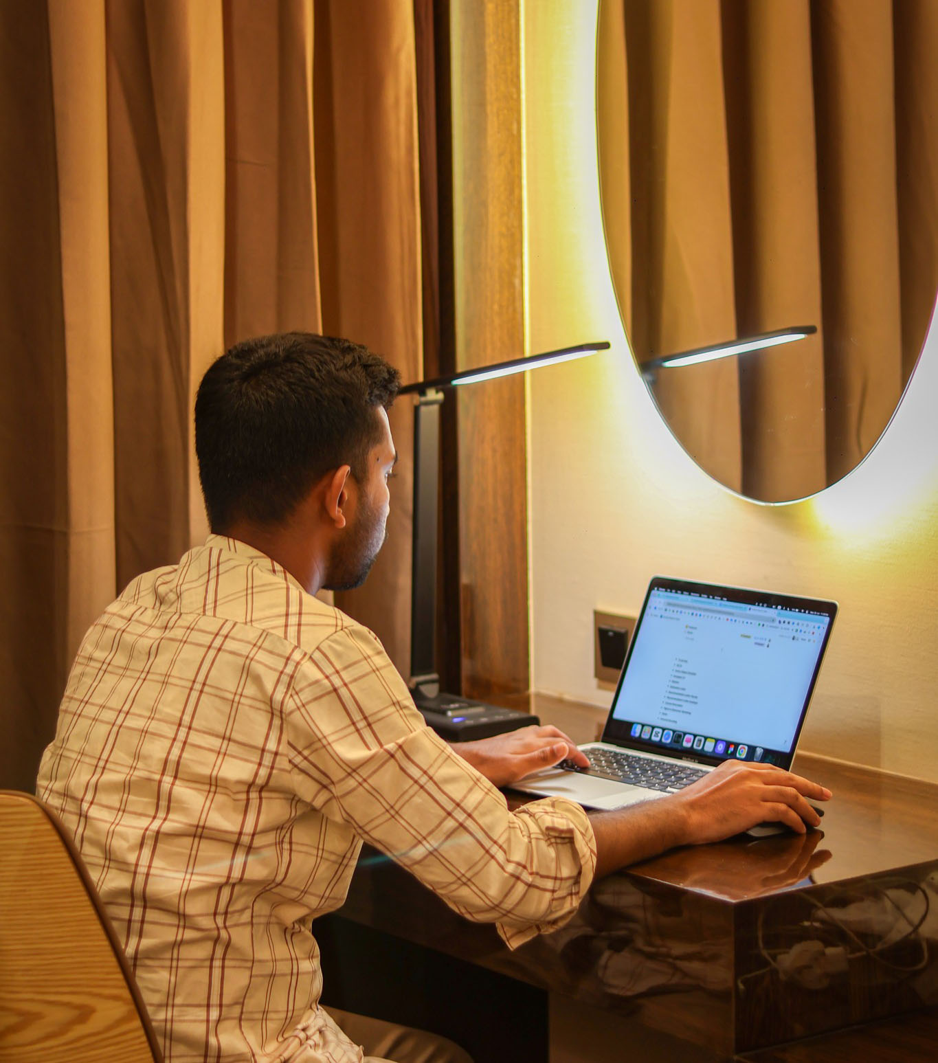 Mojibur working on a website at his desk